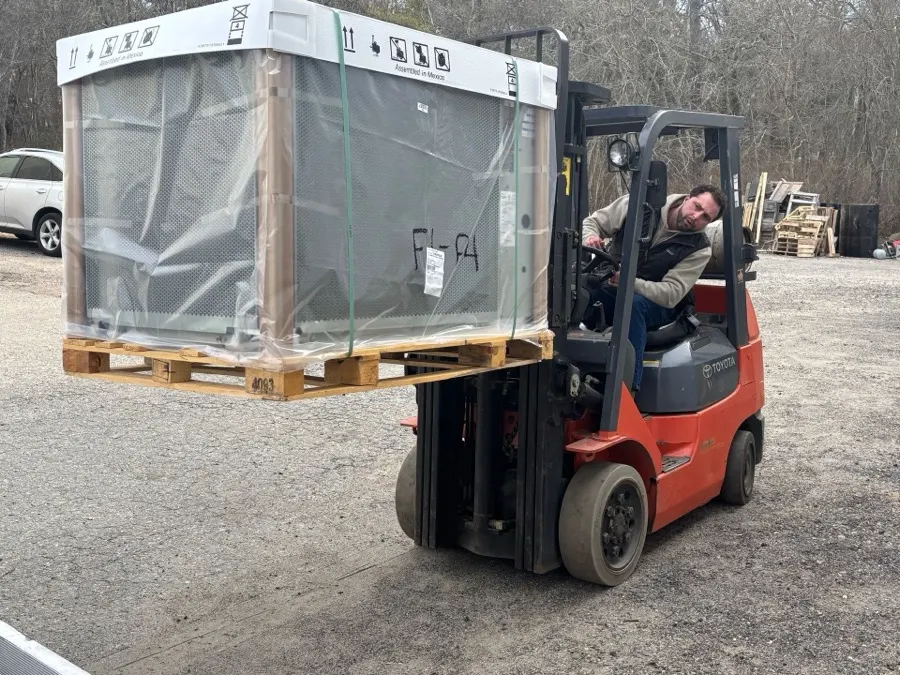 Forklift delivering HVAC equipment
